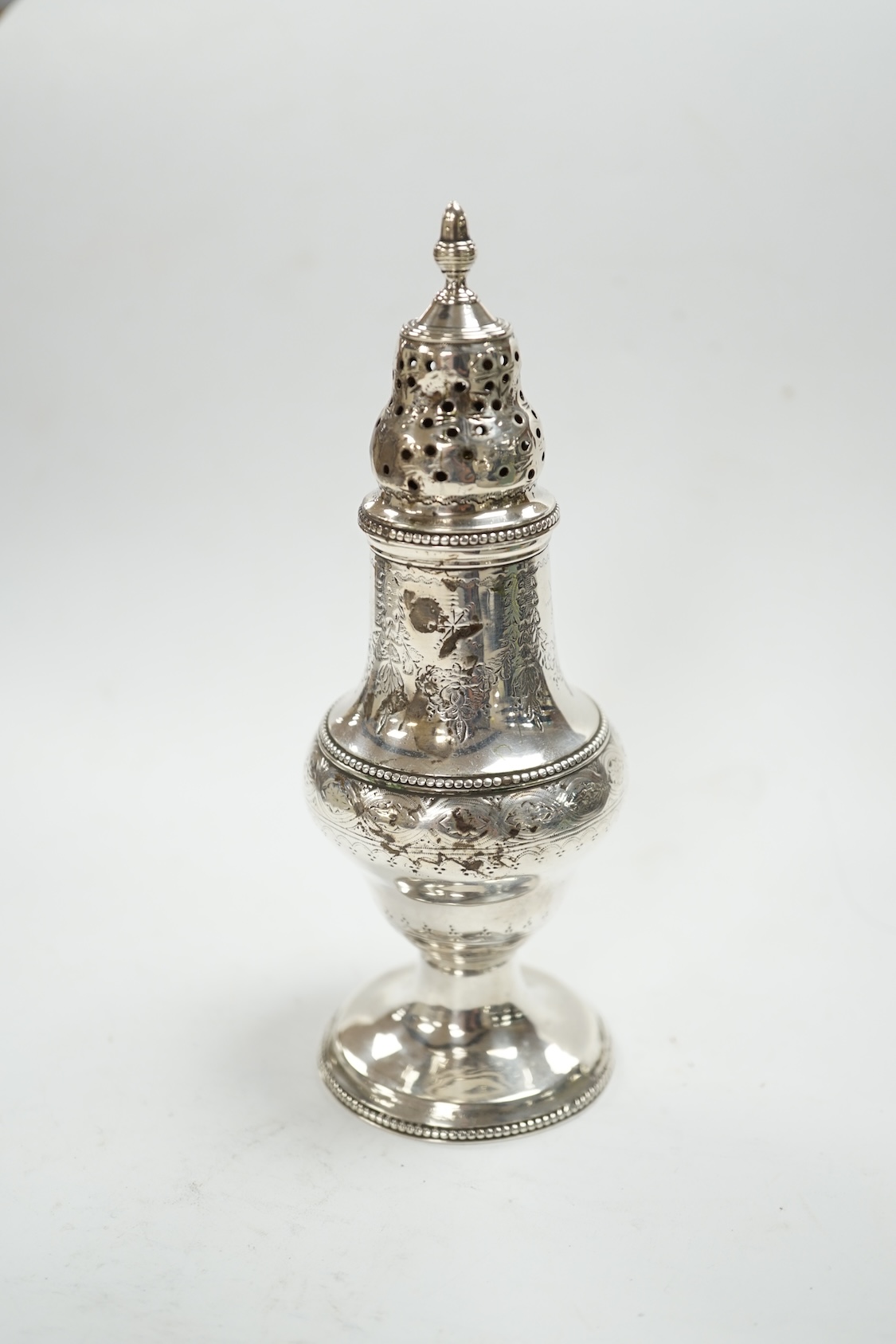 A George III silver baluster pepperette, Thomas Daniell, London, 1785, 14.6cm. Condition - poor